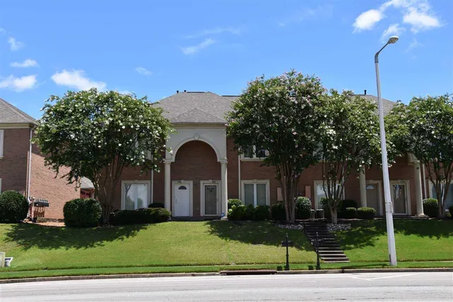 a front view of a house with a garden