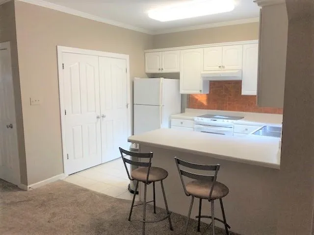 a kitchen with a table and chairs