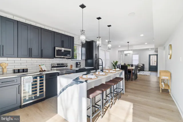 a large kitchen with lots of counter space and stainless steel appliances