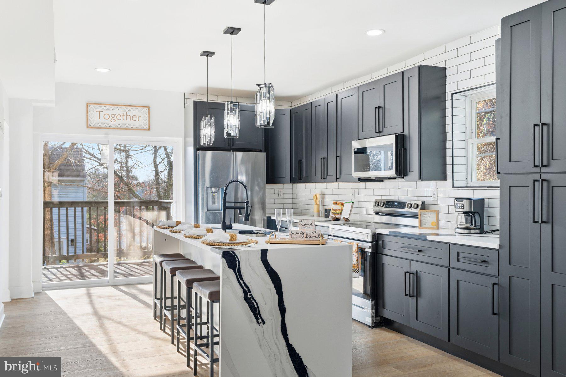 413 1st Avenue Halethorpe, MD 21227 - Photo 13 of 38 a kitchen with stainless steel appliances a sink stove refrigerator and cabinets