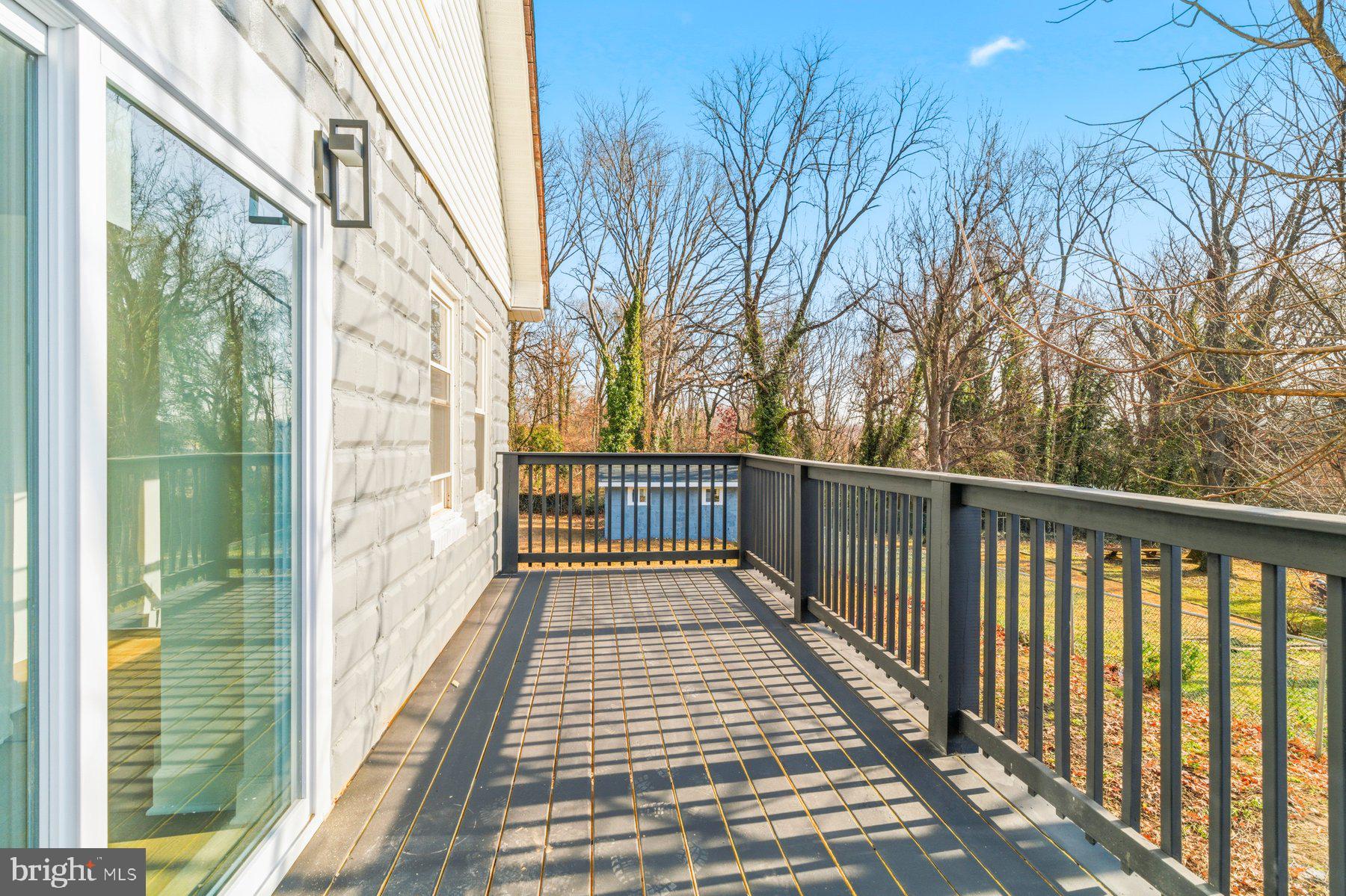 413 1st Avenue Halethorpe, MD 21227 - Photo 14 of 38 a view of a balcony with wooden floor and fence