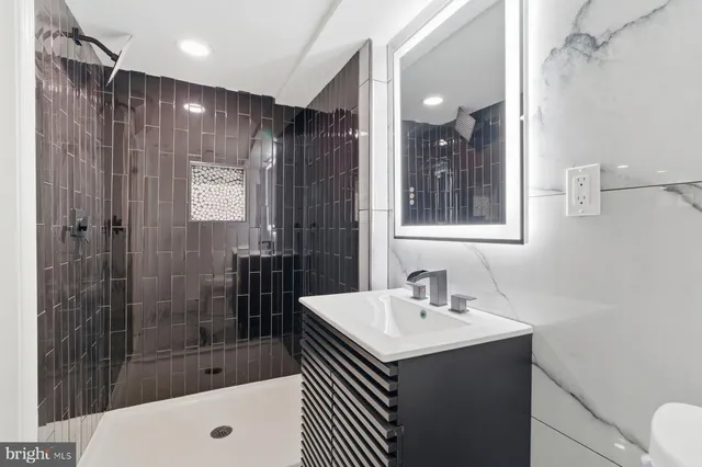 a view of an empty room with wooden floor and closet