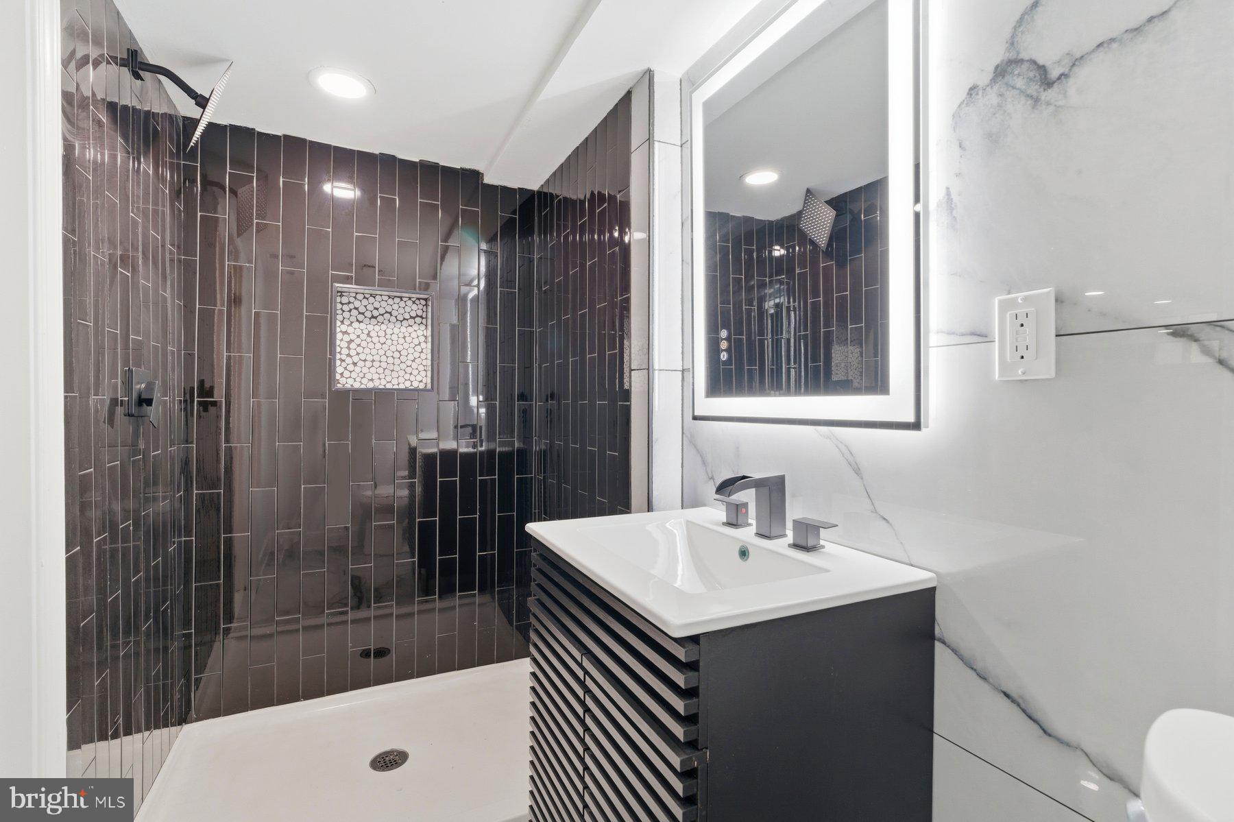 413 1st Avenue Halethorpe, MD 21227 - Photo 27 of 38 a bathroom with a sink shower and a mirror