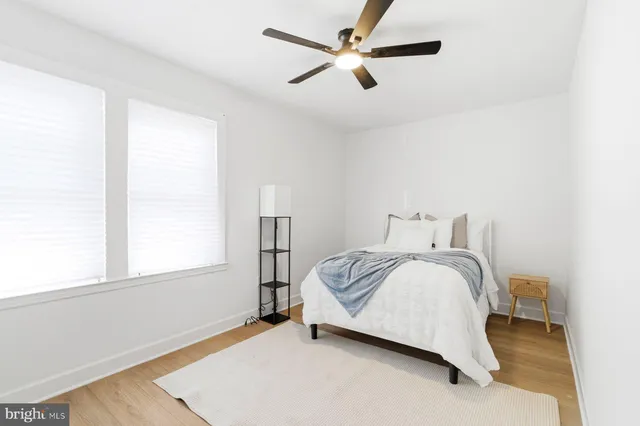 a spacious bedroom with a bed and a window