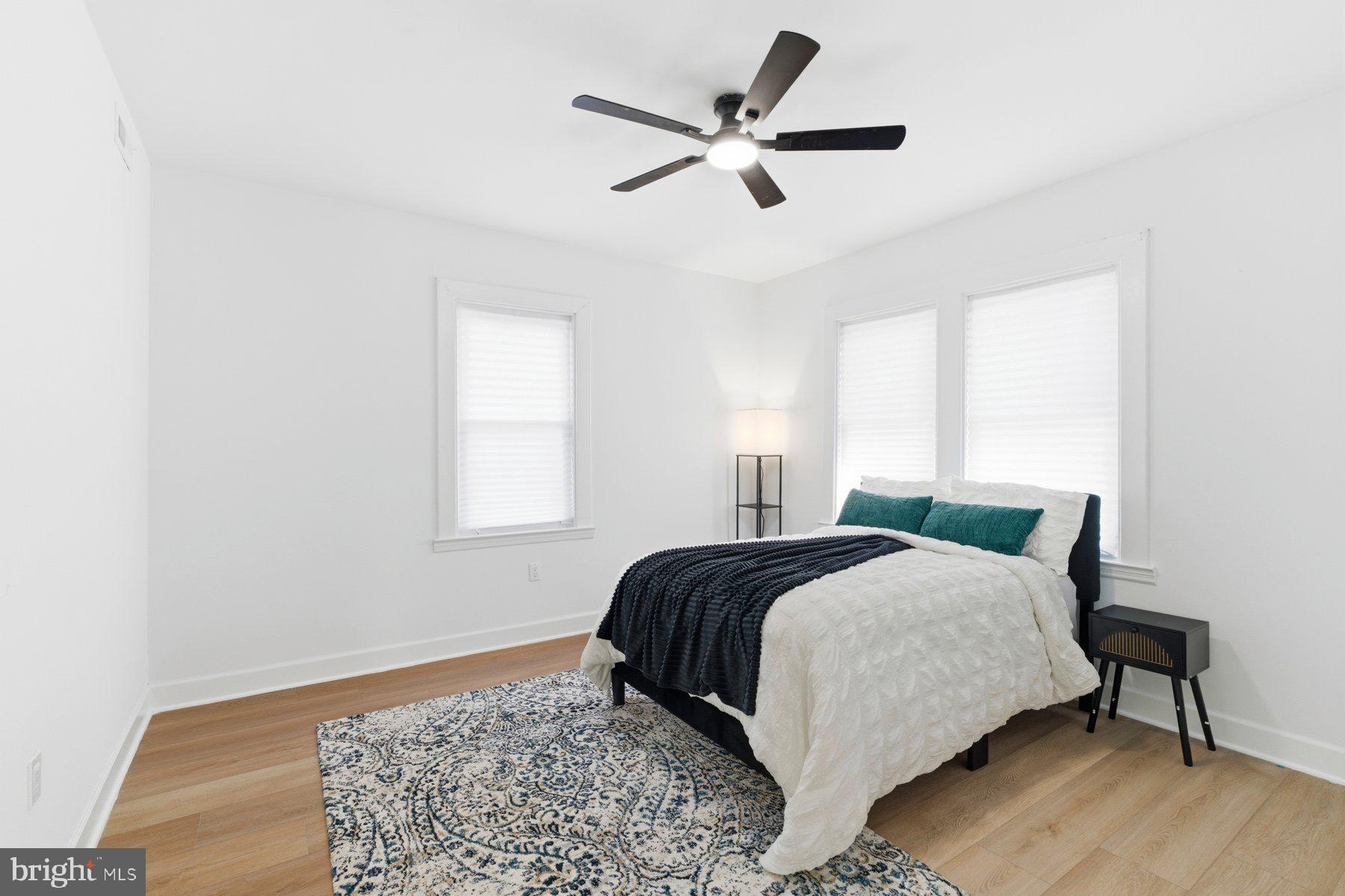 413 1st Avenue Halethorpe, MD 21227 - Photo 8 of 38 a bedroom with a bed a window and a chandelier
