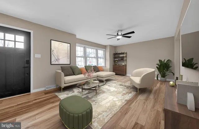a living room with furniture a chandelier and wooden floor