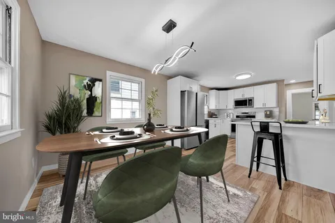 a view of a kitchen with wooden floor electronic appliances and window