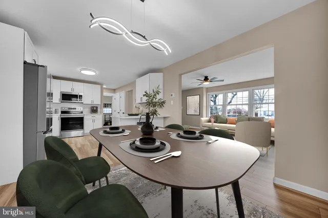 a dining room with furniture and wooden floor