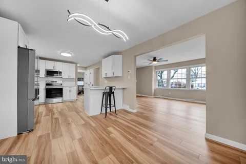 a kitchen with a refrigerator sink and cabinets