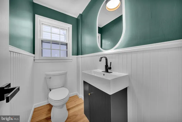 a bathroom with a toilet sink and mirror
