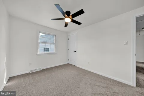 a view of a livingroom with an empty space and a hallway