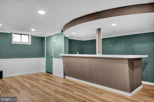 a kitchen with a sink a counter top space and cabinets