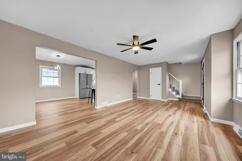 a view of kitchen with stainless steel appliances refrigerator stove microwave and cabinets