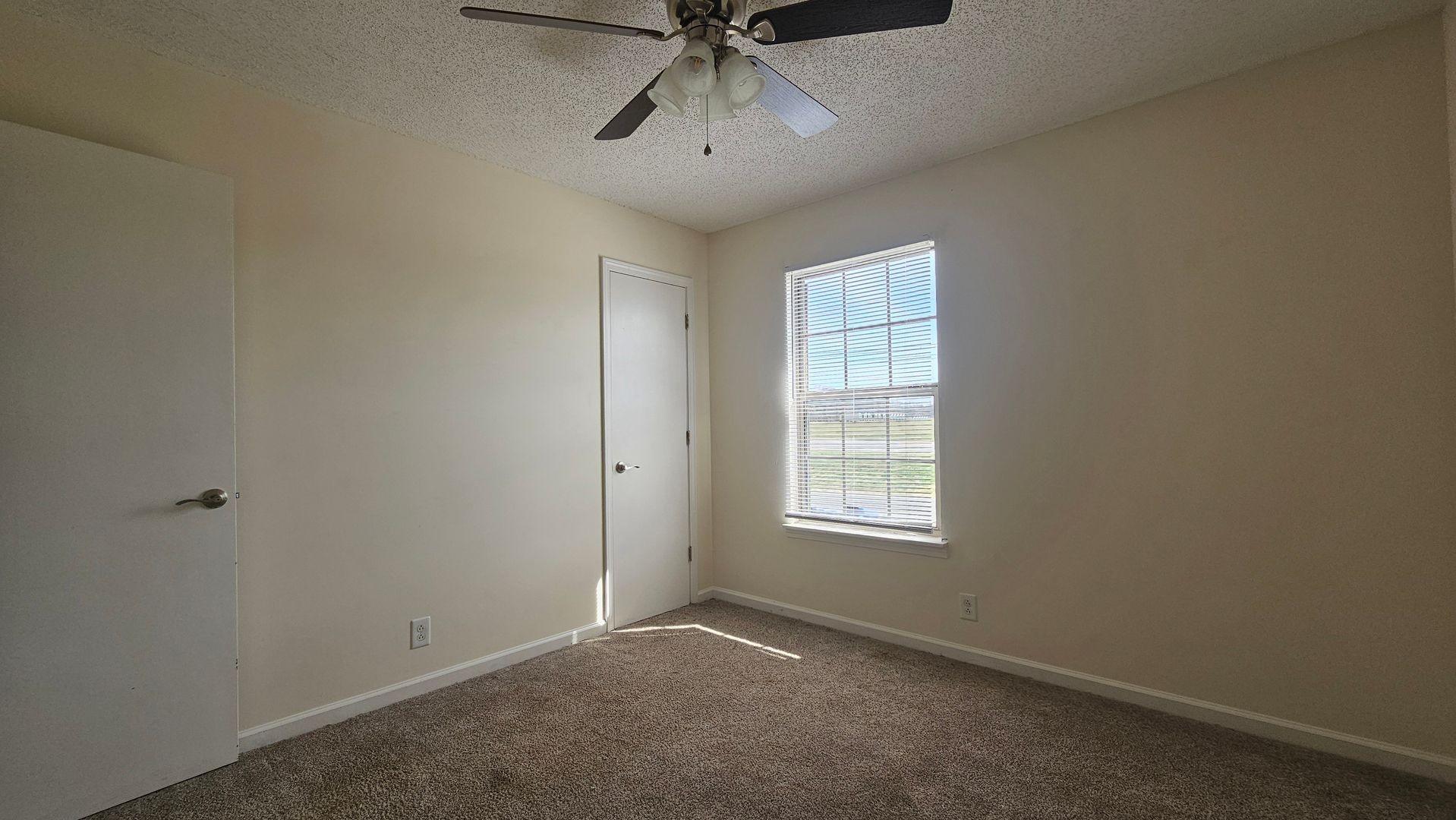 2451 Wilson Road, Unit 6 Clarksville, TN 37043 - Photo 8 of 14 an empty room with a window and a ceiling fan
