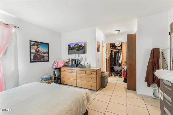 a bed room with a bed and a television