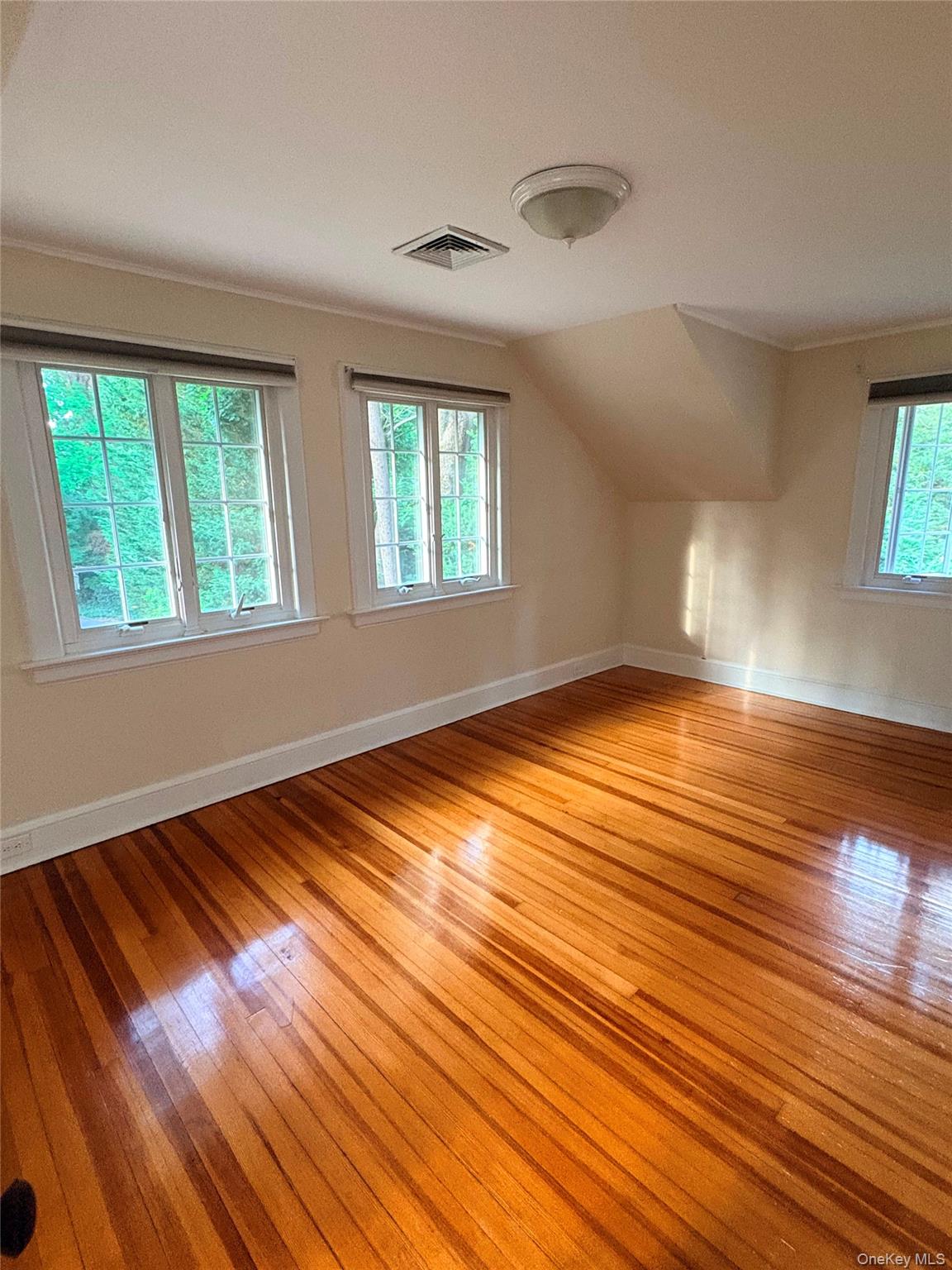 6 Tower Road Glen Cove, NY 11542 - Photo 10 of 12 a view of empty room with wooden floor and fan