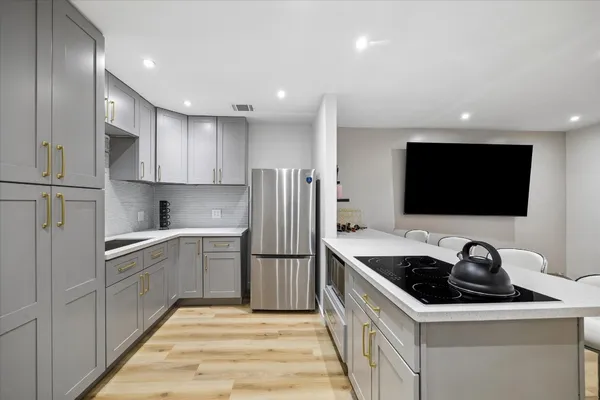 a kitchen that has a sink stainless steel appliances a counter space and cabinets