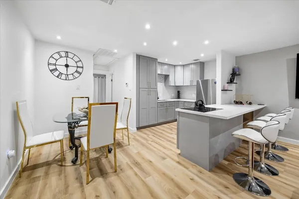 a view of a dining room with furniture and a kitchen