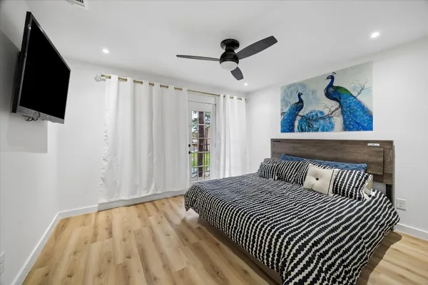 a bedroom with a bed and a flat screen tv