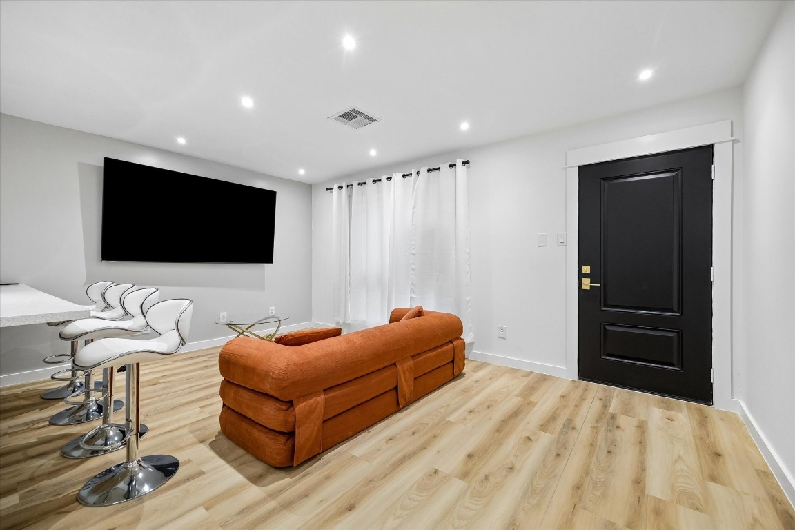 7402 Alabonson Road, Unit 202 Houston, TX 77088 - Photo 6 of 10 a living room with furniture and a flat screen tv