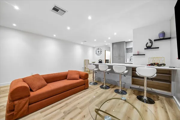 a living room with furniture a couch and a stove