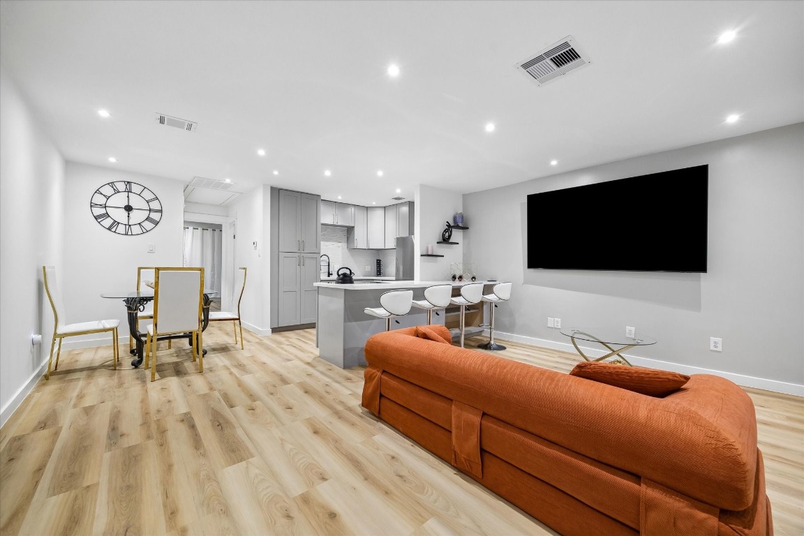 7402 Alabonson Road, Unit 202 Houston, TX 77088 - Photo 8 of 10 a living room with furniture and a flat screen tv