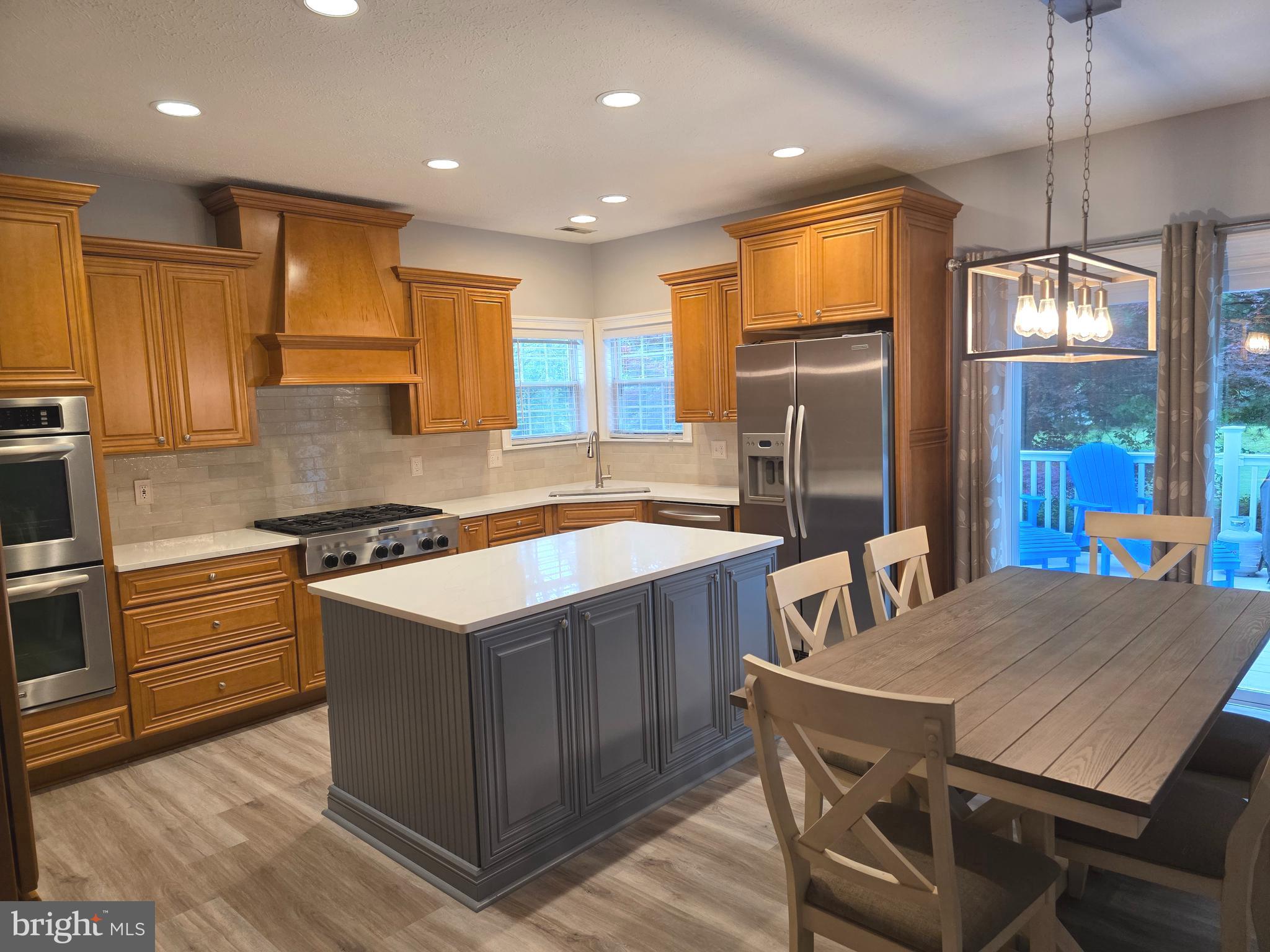 2441 Kemper Road Crofton, MD 21114 - Photo 12 of 63 a kitchen with a stove a refrigerator and wooden floor