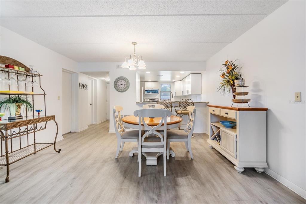 12760 Indian Rocks Road, Unit 104 Largo, FL 33774 - Photo 8 of 37 a view of a dining room with furniture and wooden floor