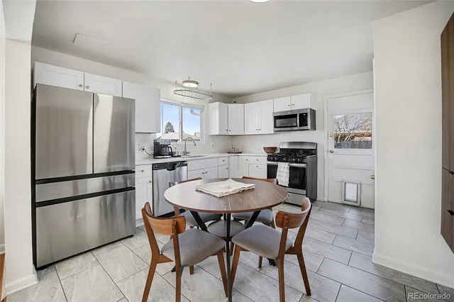 a kitchen with stainless steel appliances a refrigerator a stove a microwave and a refrigerator