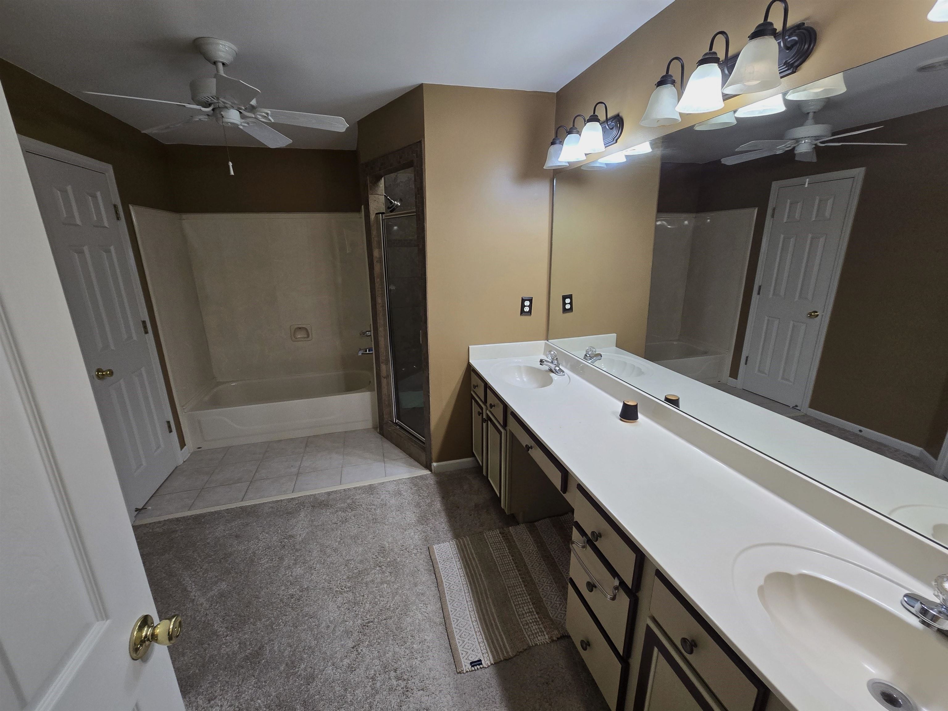 10448 Sunnybrook Circle Collierville, TN 38017 - Photo 11 of 22 a bathroom with a double vanity sink and mirror