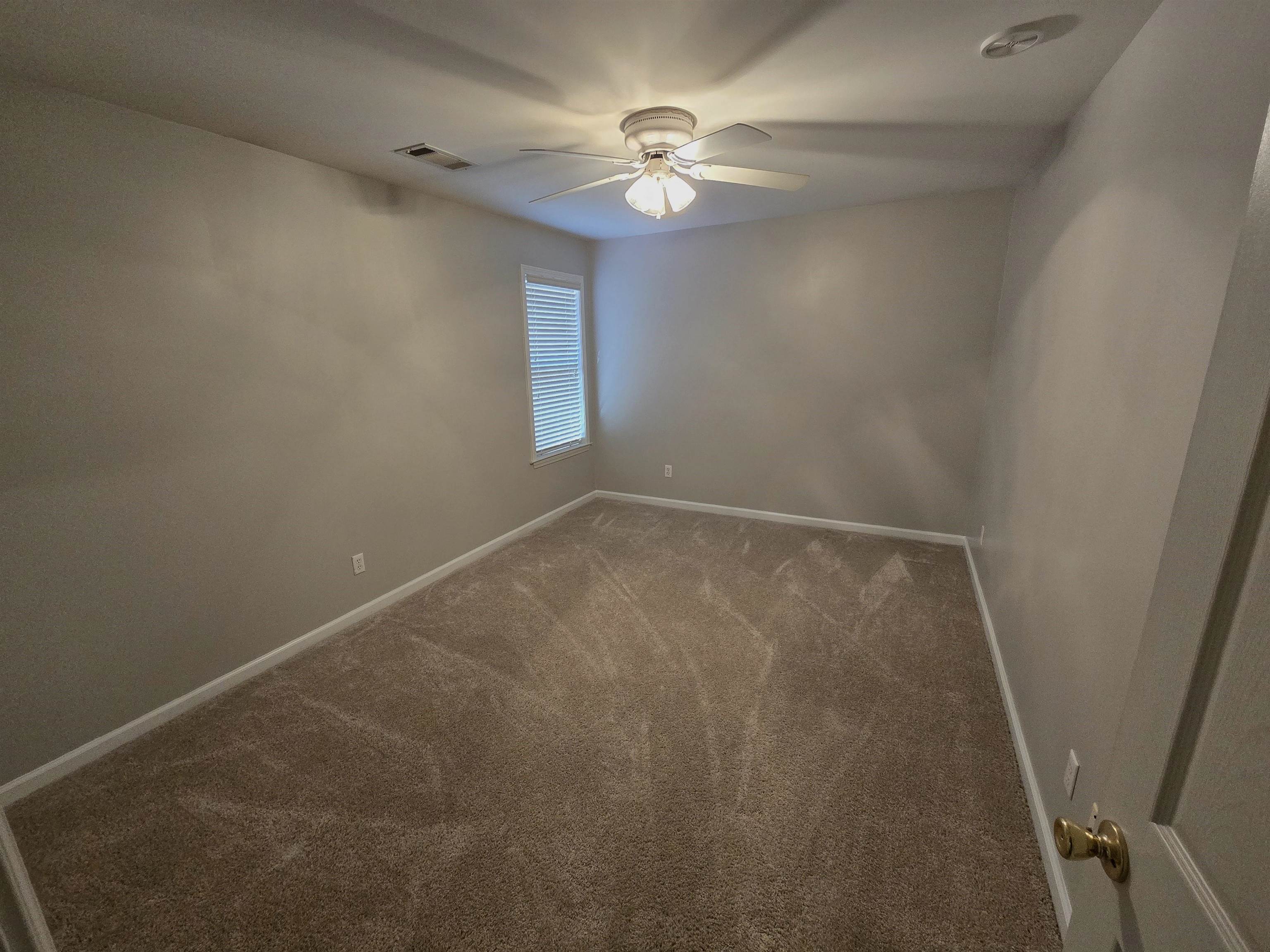 10448 Sunnybrook Circle Collierville, TN 38017 - Photo 12 of 22 an empty room with windows and fan