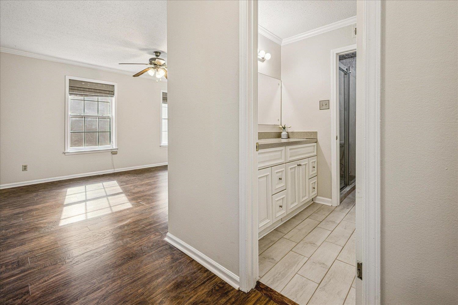 865 South Yates Road, Unit 1 Memphis, TN 38120 - Photo 11 of 25 Bathroom with light wood finished floors, vanity, ornamental molding, a stall shower, and ceiling fan