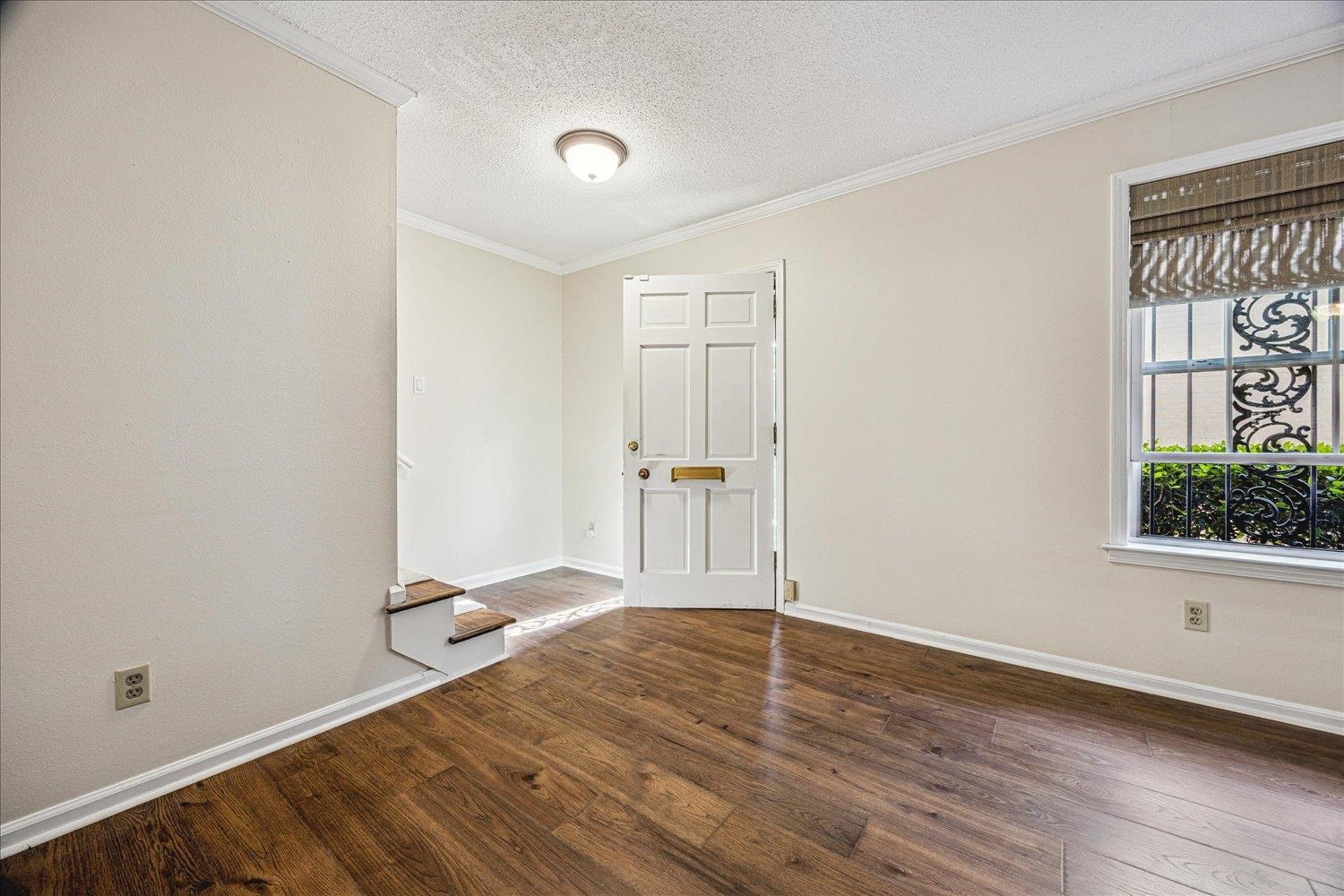 865 South Yates Road, Unit 1 Memphis, TN 38120 - Photo 16 of 25 Empty room with ornamental molding, dark wood finished floors, and a textured ceiling