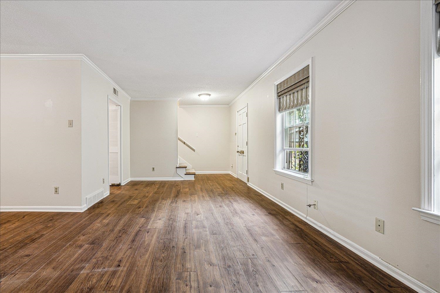 865 South Yates Road, Unit 1 Memphis, TN 38120 - Photo 4 of 25 Empty room featuring dark wood finished floors and ornamental molding