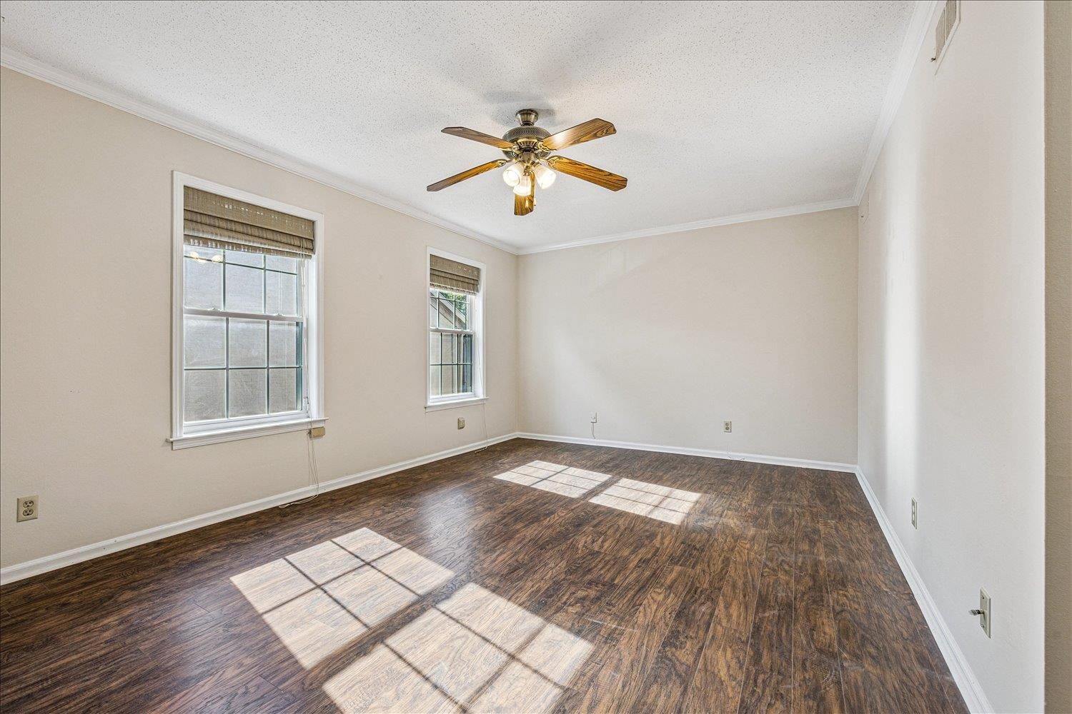 865 South Yates Road, Unit 1 Memphis, TN 38120 - Photo 10 of 25 Empty room featuring a ceiling fan, dark wood-type flooring, crown molding, and a textured ceiling