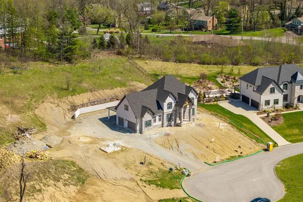 an aerial view of a house with a swimming pool