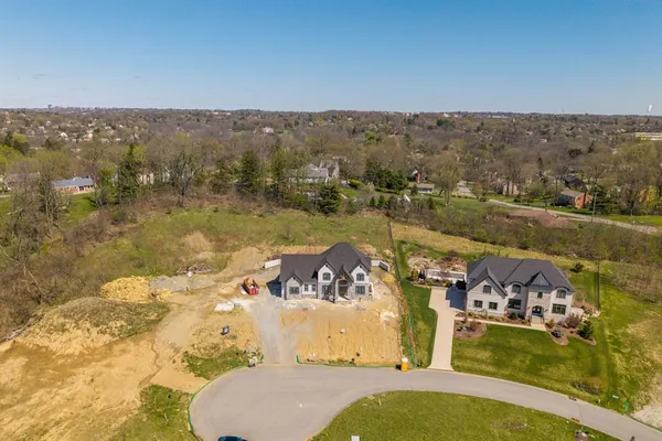 an aerial view of a house with yard swimming pool and lake view