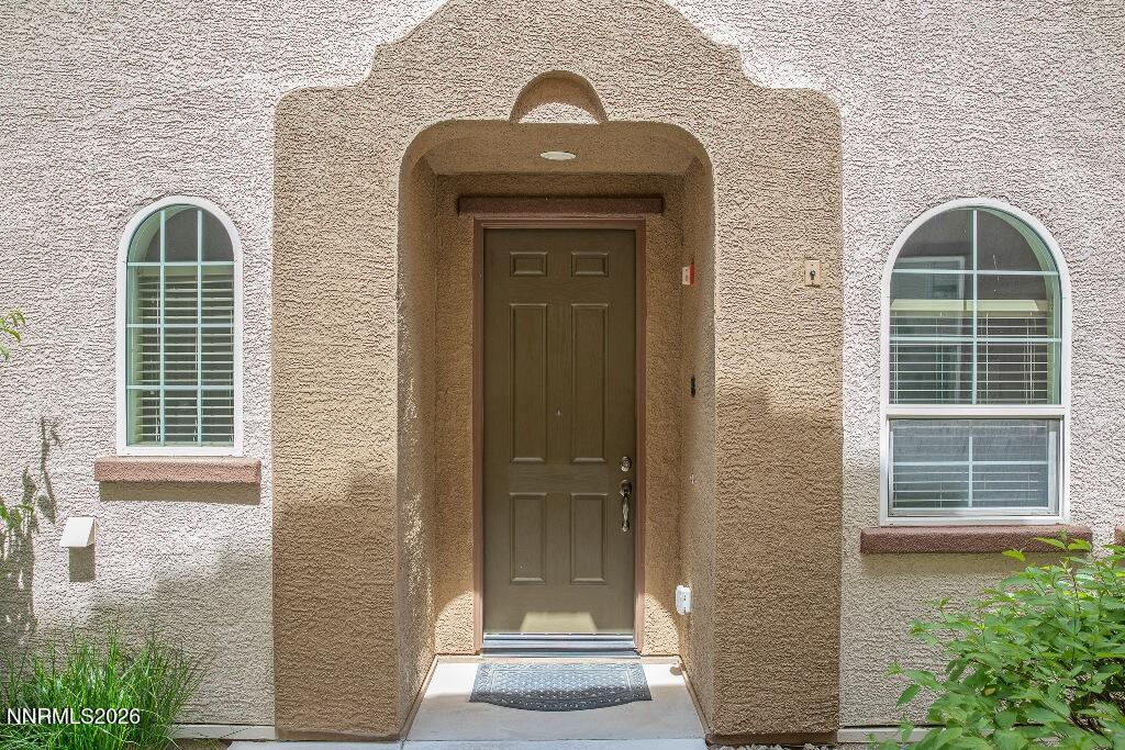 1864 Wind Ranch Road, Unit B Reno, NV 89521 - Photo 4 of 42 a front view of a house with large windows