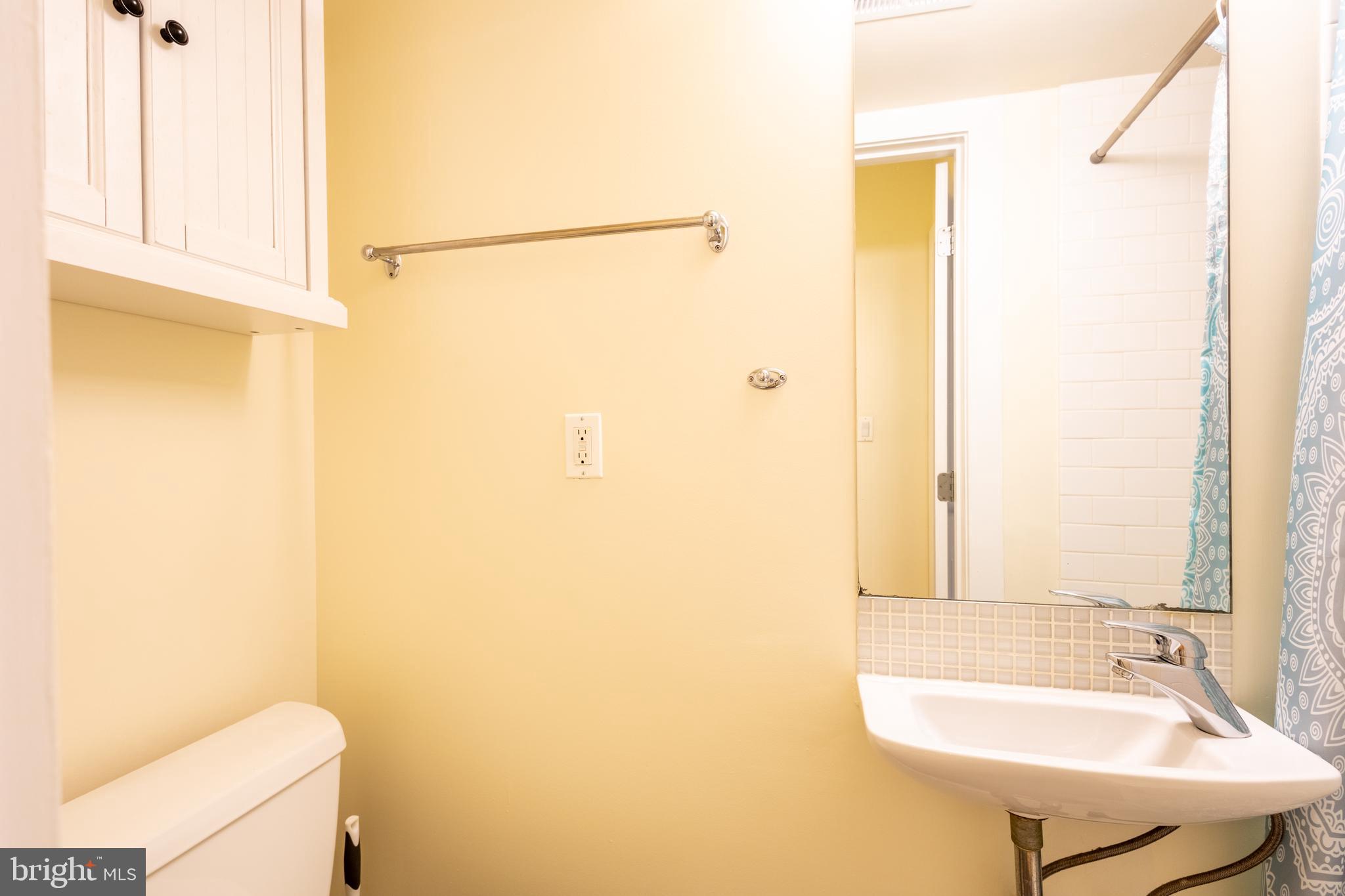 1123 6th Street Northwest, Unit 1 Washington, DC 20001 - Photo 11 of 19 a bathroom with a sink and a mirror