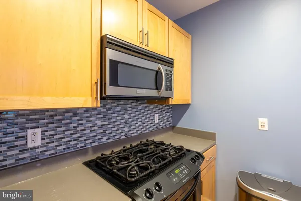 a kitchen with stove and cabinets