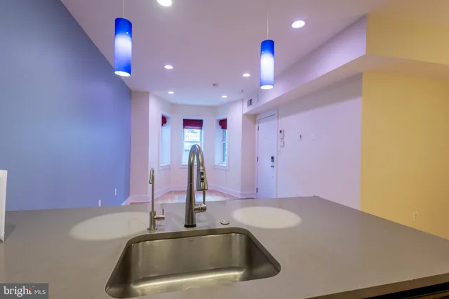 a kitchen with a sink and chandelier
