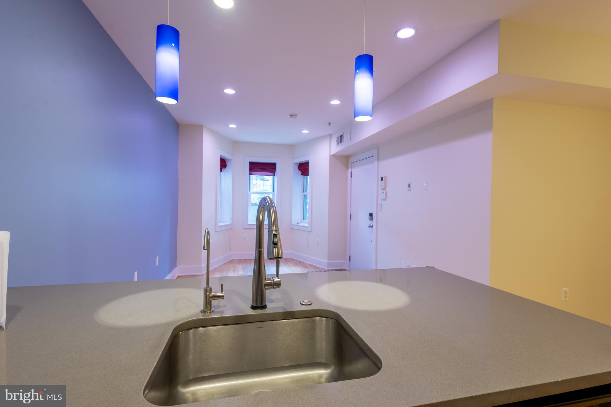 1123 6th Street Northwest, Unit 1 Washington, DC 20001 - Photo 15 of 19 a kitchen with a sink and chandelier