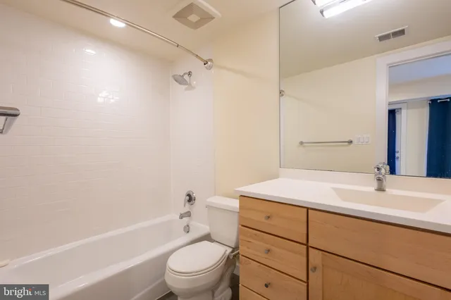 a bathroom with a sink toilet vanity and shower