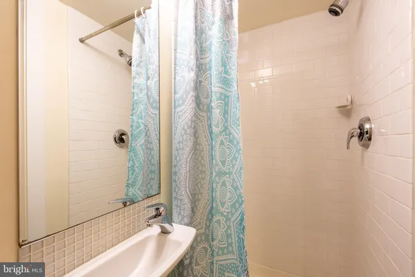 a bathroom with a sink and shower