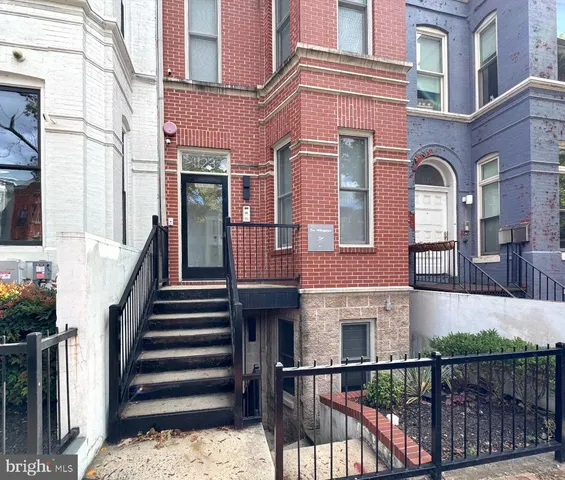 a front view of a house with a fence