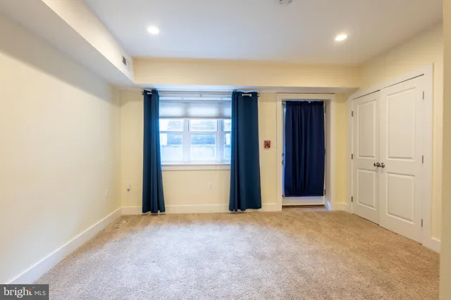 an empty room with closet and wooden floor
