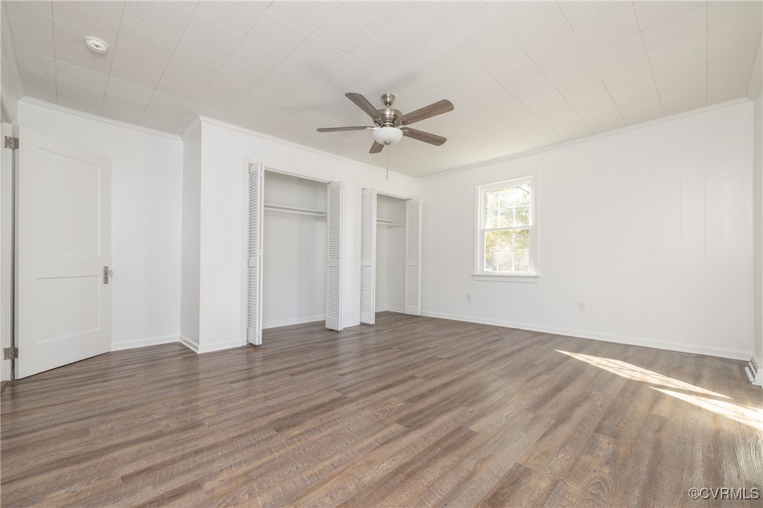 19503 Ahern Road Moseley, VA 23120 - Photo 17 of 29 an empty room with wooden floor ceiling fan and windows
