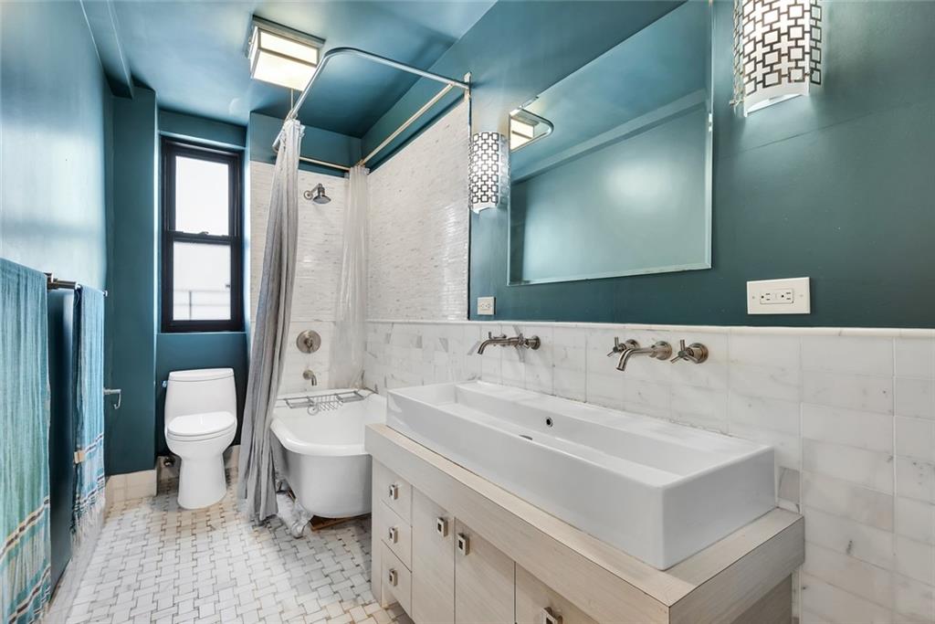 135 Eastern Parkway, Unit 7E Brooklyn, NY 11238 - Photo 12 of 17 a bathroom with a sink and a mirror