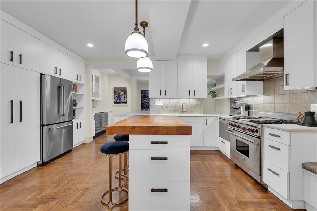 135 Eastern Parkway, Unit 7E Brooklyn, NY 11238 - Photo 2 of 17 a kitchen with white cabinets and stainless steel appliances