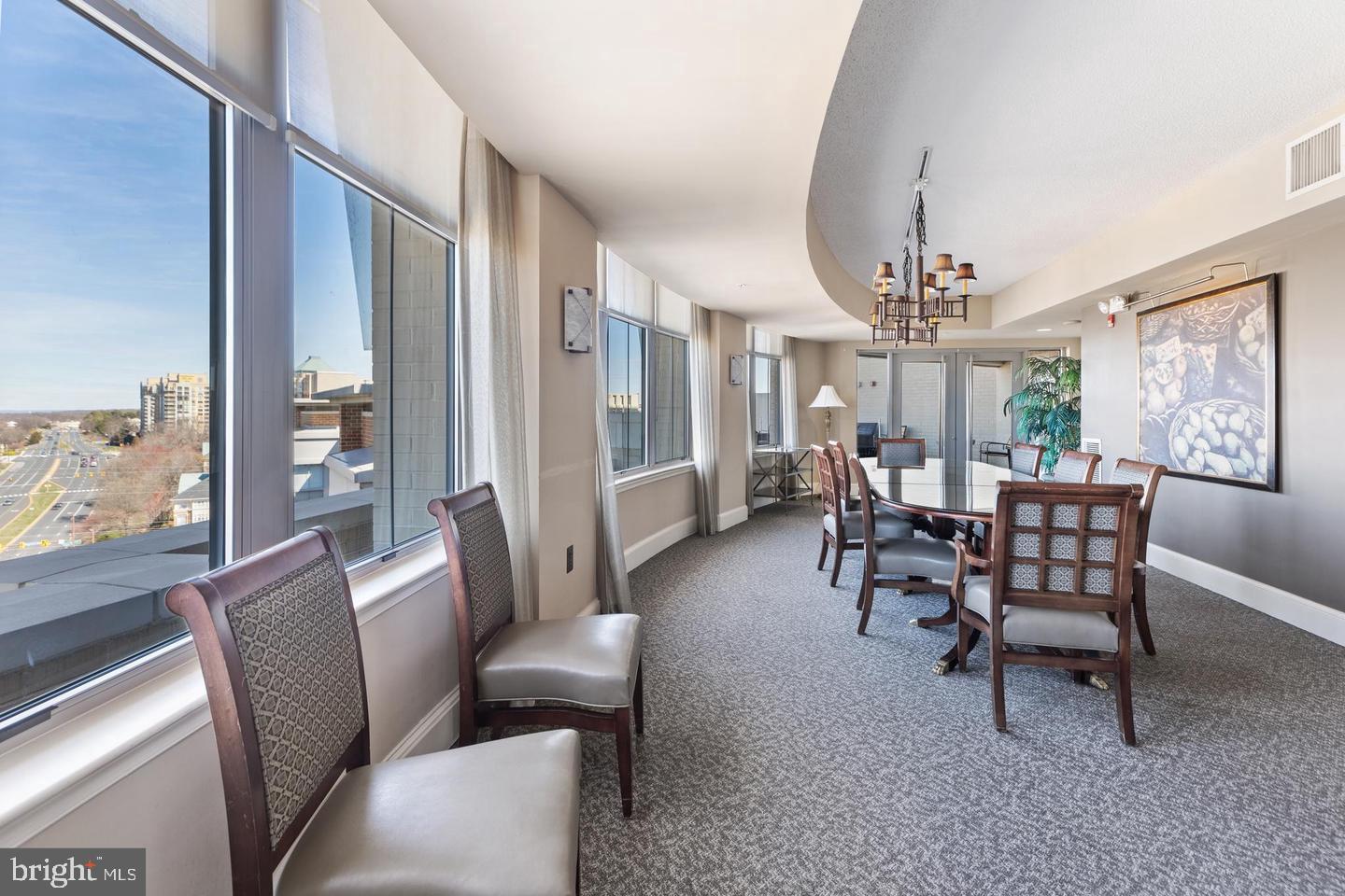 11800 Sunset Hills Road, Unit 314 Reston, VA 20190 - Photo 38 of 50 a dining room with furniture a chandelier and wooden floor